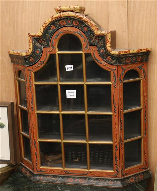 A Dutch style floral polychrome painted wall cupboard with arched glazed door W.63cm